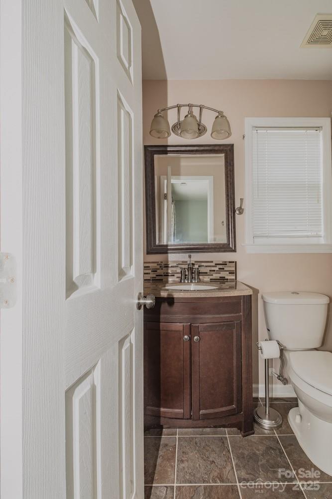 5622 Osprey Cove Drive Raleigh, NC 27604 - Photo 23 of 30 a bathroom with a toilet sink and mirror