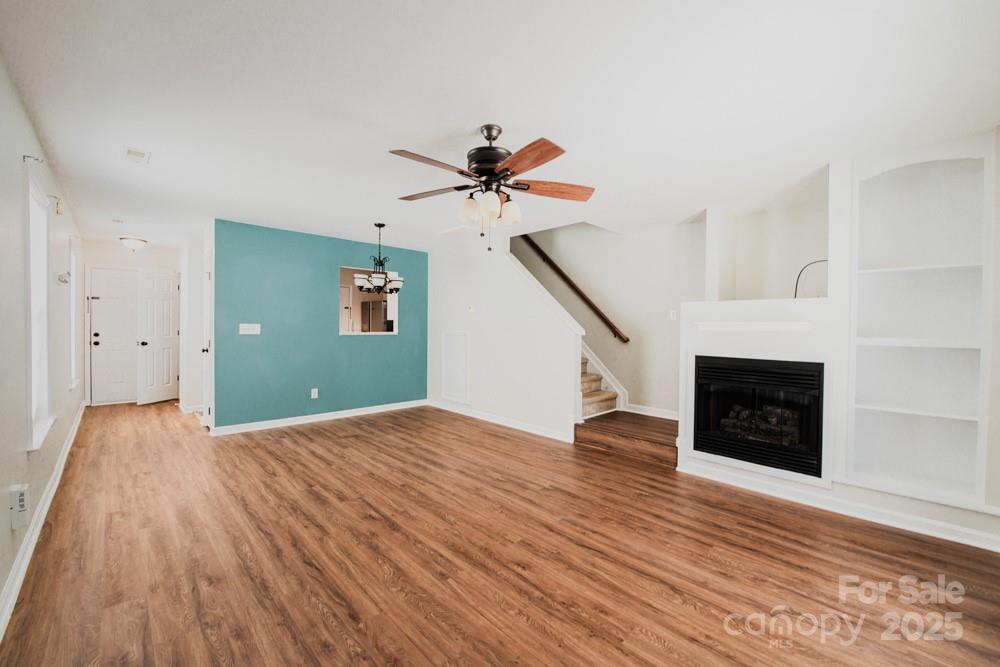 5622 Osprey Cove Drive Raleigh, NC 27604 - Photo 4 of 30 a view of empty room with wooden floor and fireplace