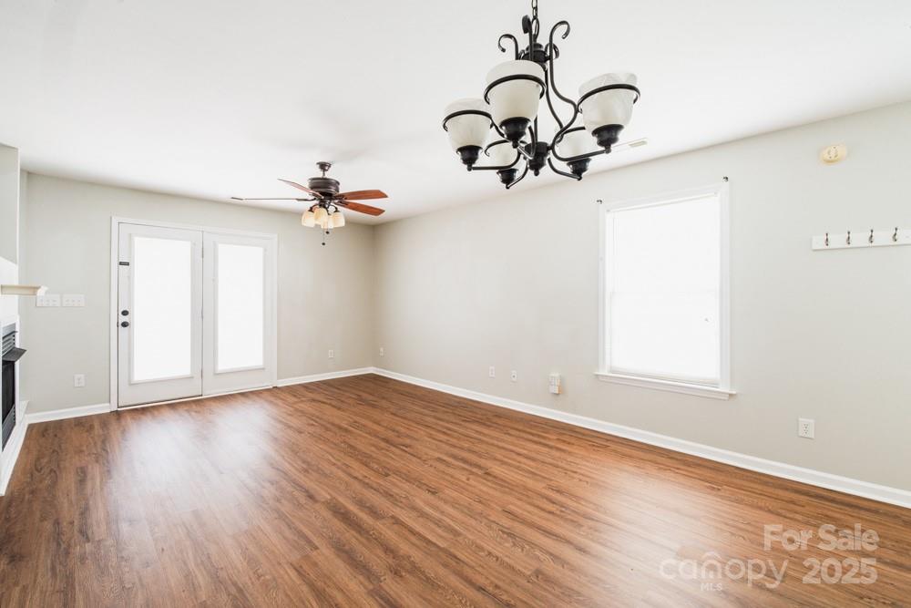 5622 Osprey Cove Drive Raleigh, NC 27604 - Photo 6 of 30 a view of a room with wooden floor and a chandelier
