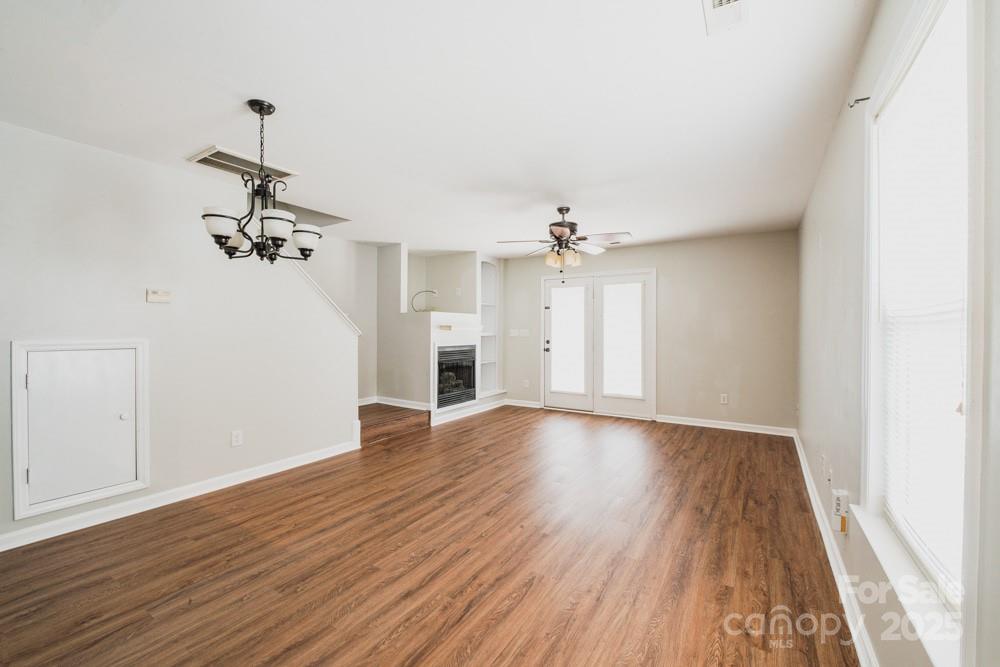 5622 Osprey Cove Drive Raleigh, NC 27604 - Photo 7 of 30 a view of a room with wooden floor and ceiling fan