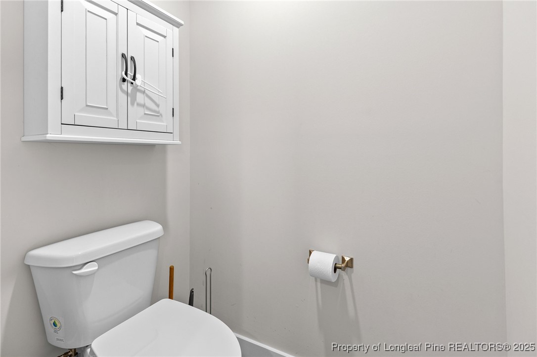 1423 Creekwood Road Hope Mills, NC 28348 - Photo 30 of 49 a white toilet sitting next to a bathroom sink