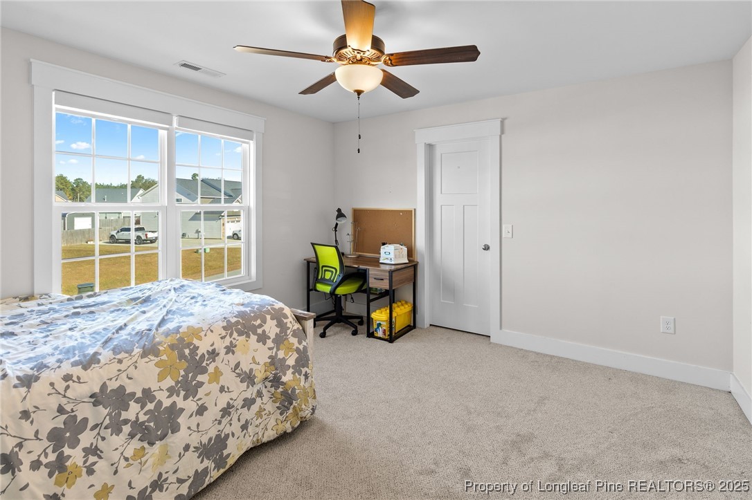 1423 Creekwood Road Hope Mills, NC 28348 - Photo 34 of 49 a bedroom with a bed and a chandelier