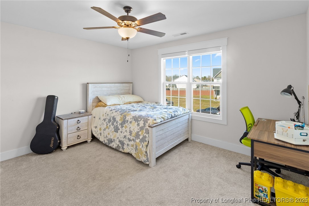 1423 Creekwood Road Hope Mills, NC 28348 - Photo 35 of 49 a bedroom with a bed and a chandelier