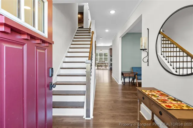 a kitchen with granite countertop stainless steel appliances wooden cabinets a stove and a refrigerator