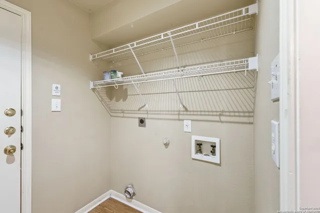 an empty room with closet and a chandelier fan