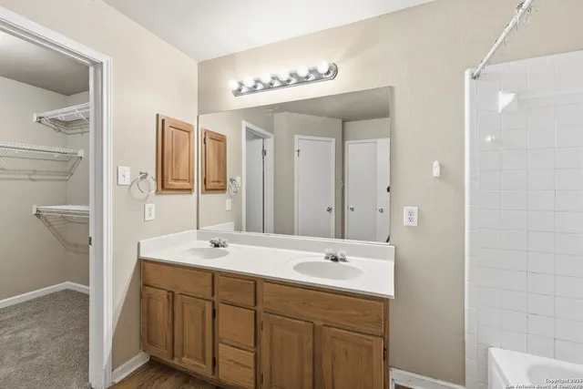 a view of house with backyard and tree in the background