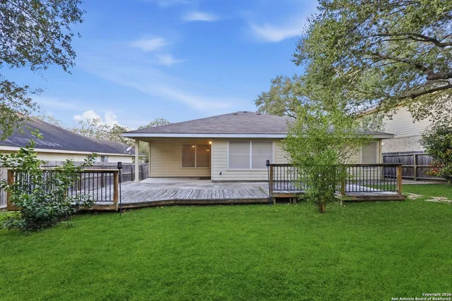 a view of a house with a yard plants and tree
