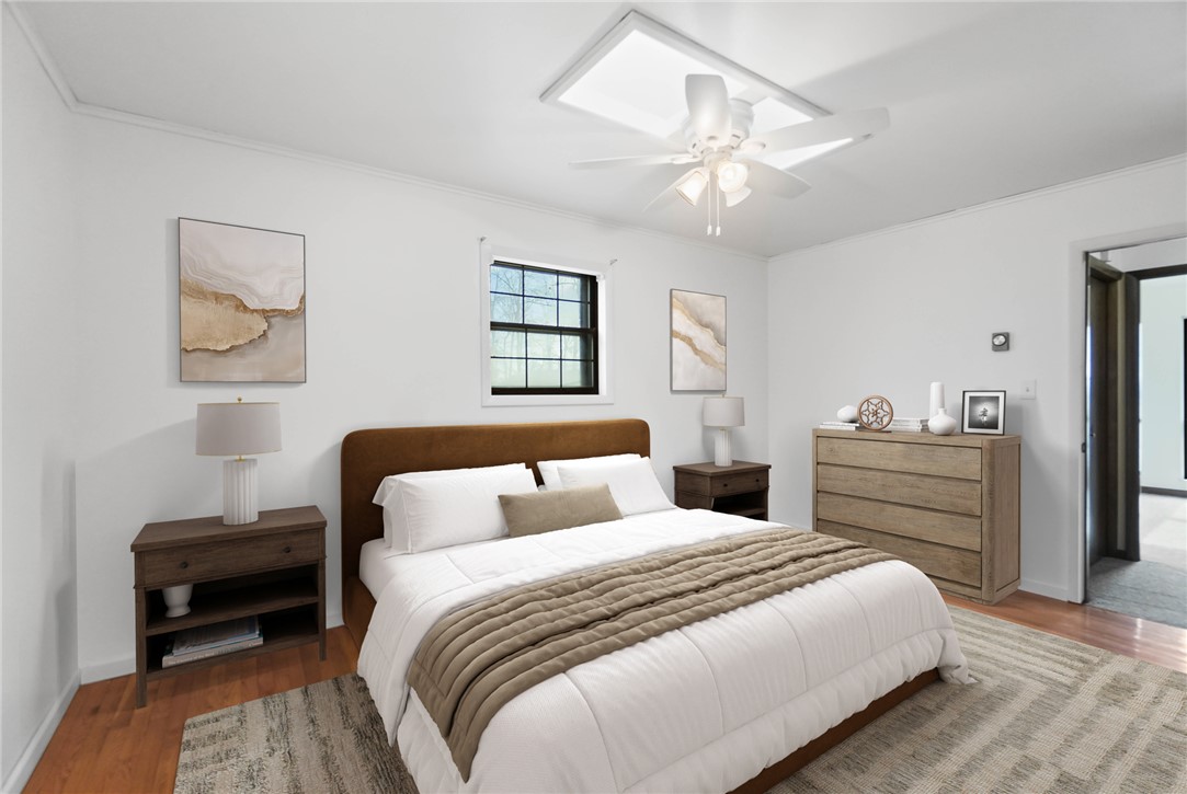 14333 Meranda Road Anna, OH 45302 - Photo 29 of 98 This tranquil bedroom features hardwood floors and a contemporary ceiling fan, offering comfort and style.
