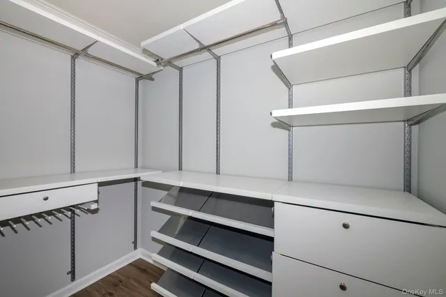a view of cabinets and utility room with wooden floor