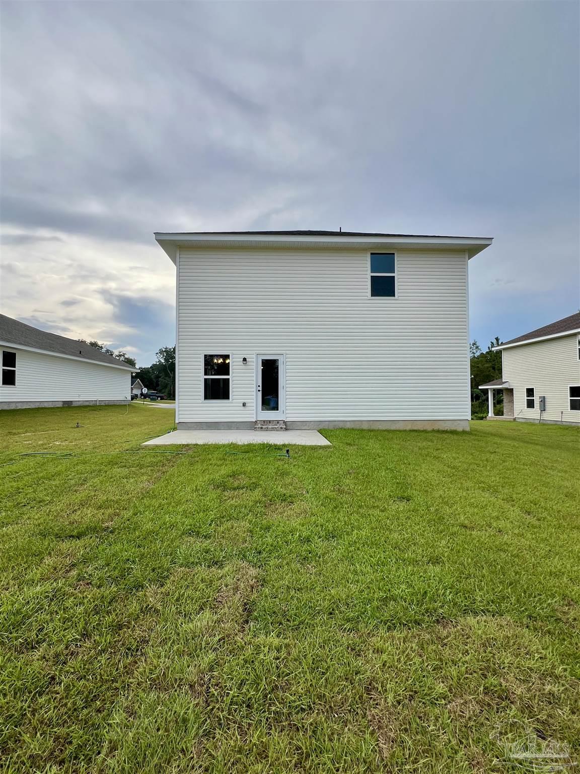 940 Rustling Pnes Road, Unit 13B Cantonment, FL 32533 - Photo 14 of 14 a house view with a garden space