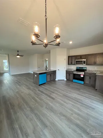 a view of an empty room and wooden floor
