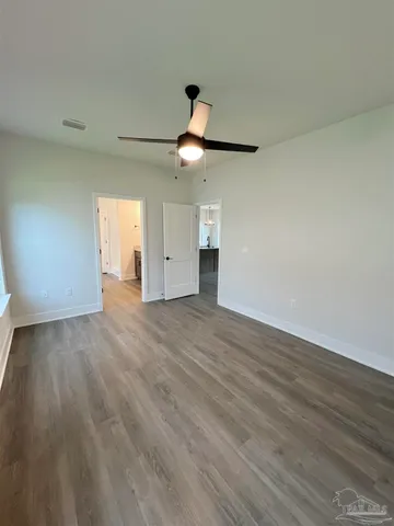 a spacious bathroom with a granite countertop sink mirror and toilet