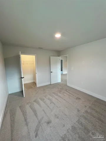 a bathroom with a granite countertop double vanity sink and a mirror