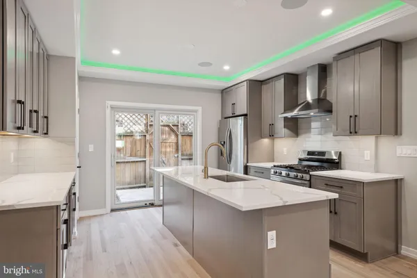 a kitchen with a sink cabinets and wooden floor