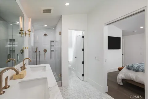 a bathroom with a tub sink mirror and shower