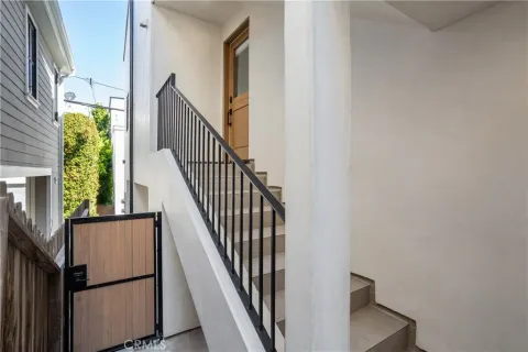 a view of staircase with wooden floor and white walls