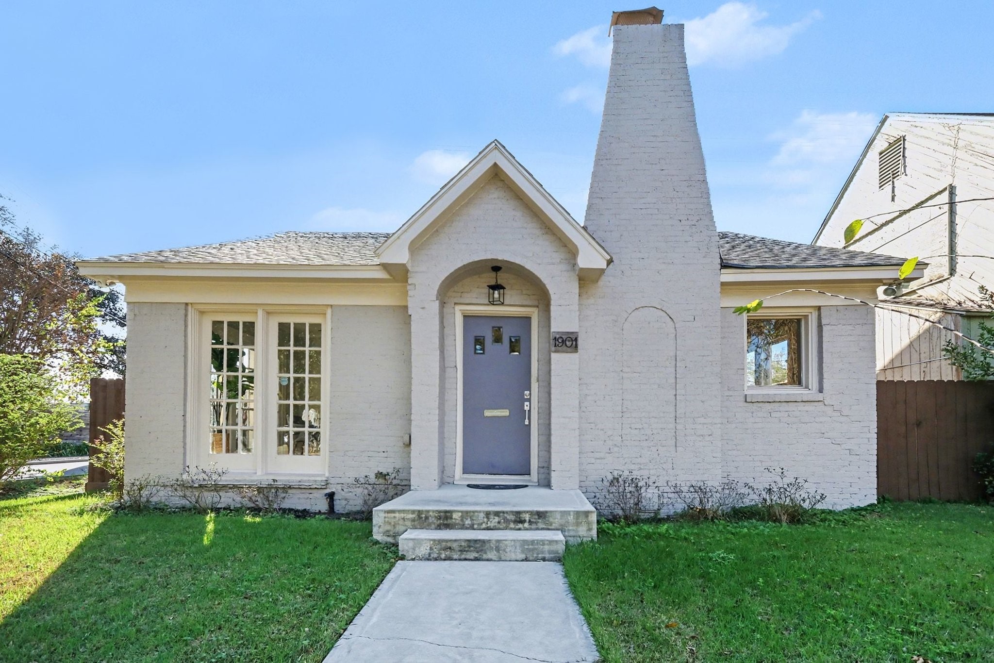 1901 Lexington Street Houston, TX 77098 - Photo 31 of 32 Front exterior of home showcases a unique chimney and arched entryway reminiscent of another time.