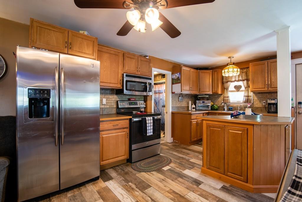2 Chestnut Street Leicester, MA 01611 - Photo 7 of 30 a kitchen with stainless steel appliances kitchen island granite countertop a refrigerator a sink a stove and dishwasher