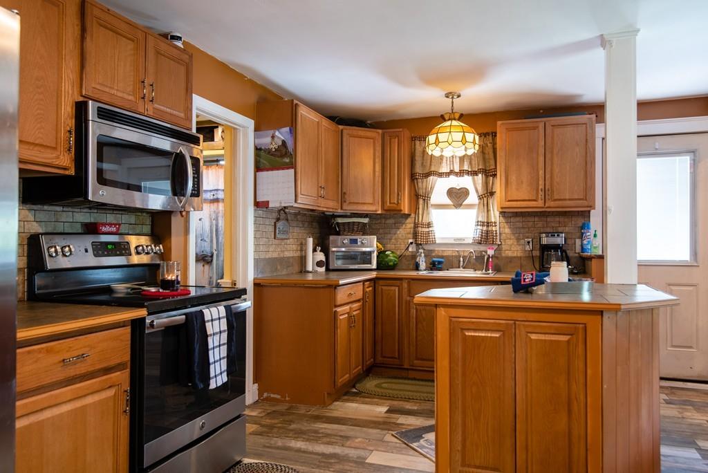 2 Chestnut Street Leicester, MA 01611 - Photo 9 of 30 a kitchen with stainless steel appliances granite countertop a stove a sink and a microwave