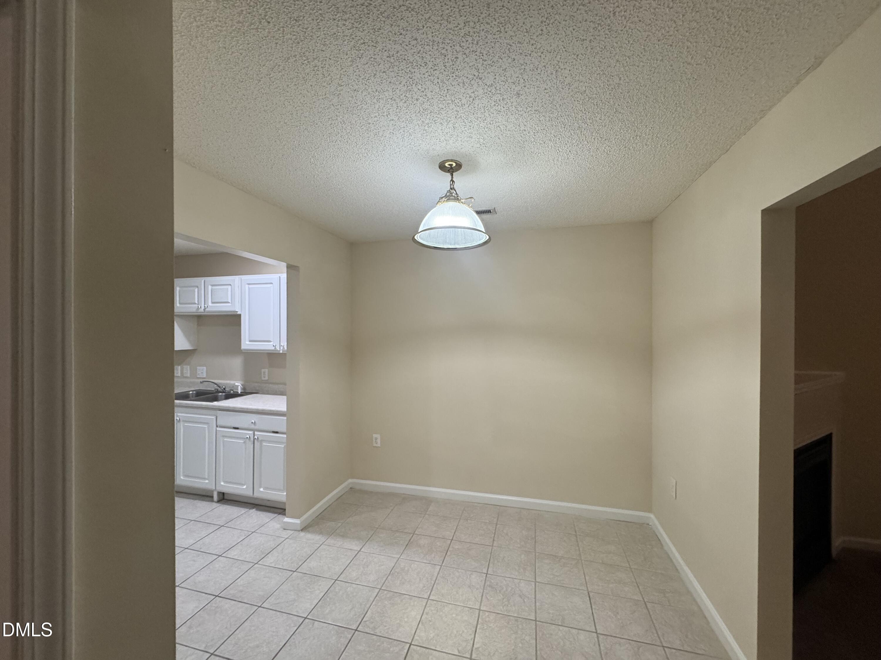 Undisclosed Address Raleigh, NC 27617 - Photo 13 of 22 a view of a kitchen with a sink and a refrigerator