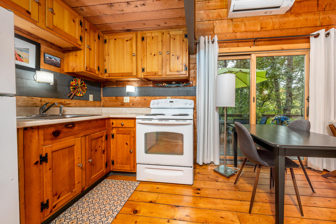 1780 Route 6, Unit B3 Wellfleet, MA 02667 - Photo 8 of 22 a kitchen with stainless steel appliances granite countertop a stove a sink and a microwave