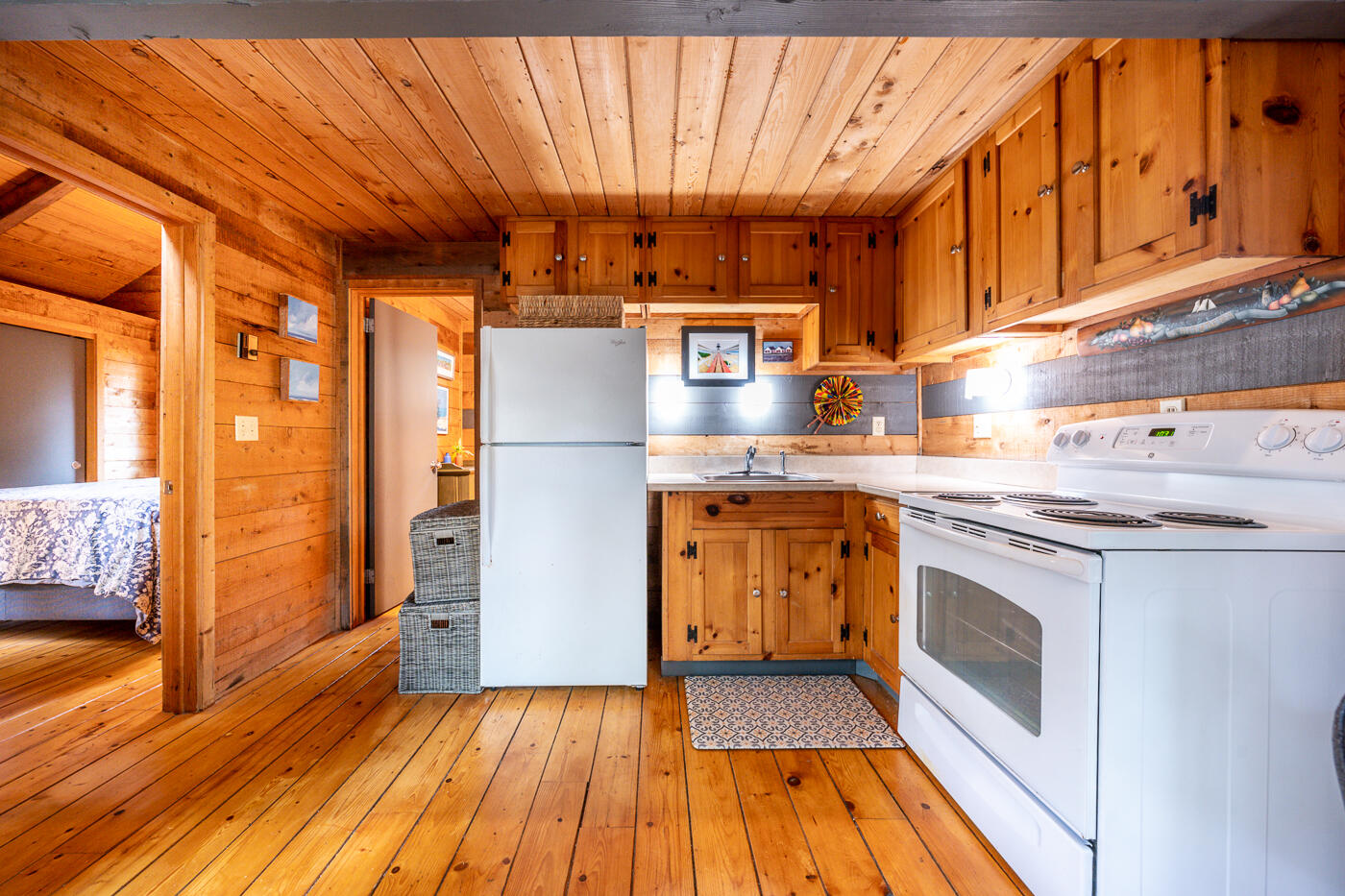 1780 Route 6, Unit B3 Wellfleet, MA 02667 - Photo 9 of 22 a kitchen with granite countertop wooden floors and stainless steel appliances
