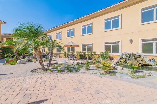 a view of a backyard with a patio and outdoor seating