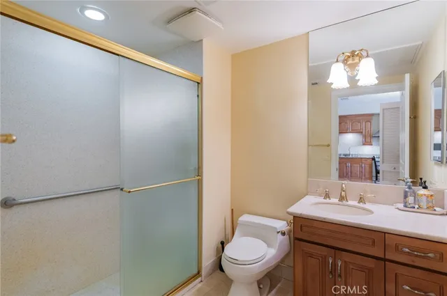 a bathroom with a sink mirror vanity and toilet