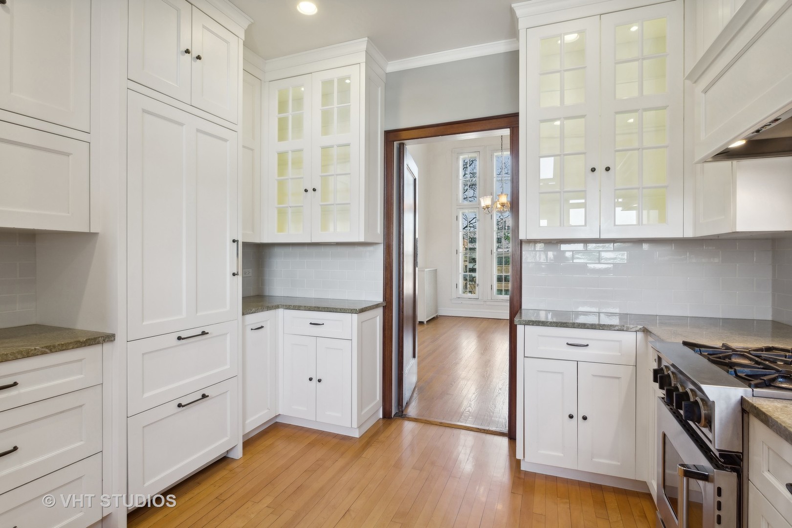 482 Sheridan Road, Unit 3 Evanston, IL 60202 - Photo 16 of 39 a kitchen with white cabinets and wooden floor