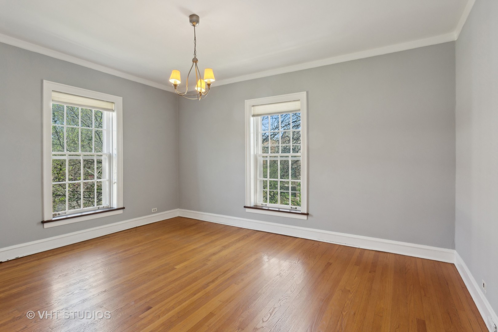 482 Sheridan Road, Unit 3 Evanston, IL 60202 - Photo 19 of 39 an empty room with wooden floor chandelier and windows
