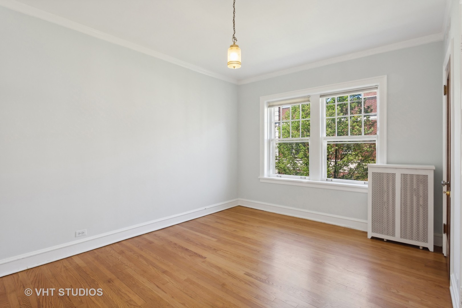 482 Sheridan Road, Unit 3 Evanston, IL 60202 - Photo 23 of 39 an empty room with wooden floor and windows