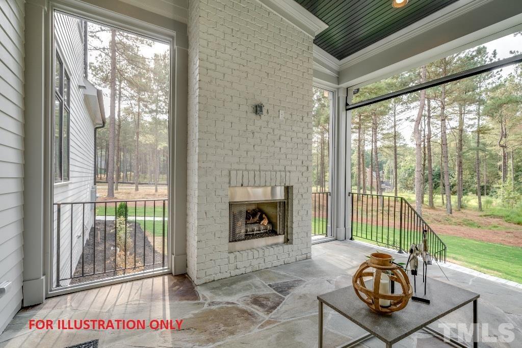 1317 Westfield Avenue Raleigh, NC 27607 - Photo 25 of 29 a living room with a fireplace and a floor to ceiling window