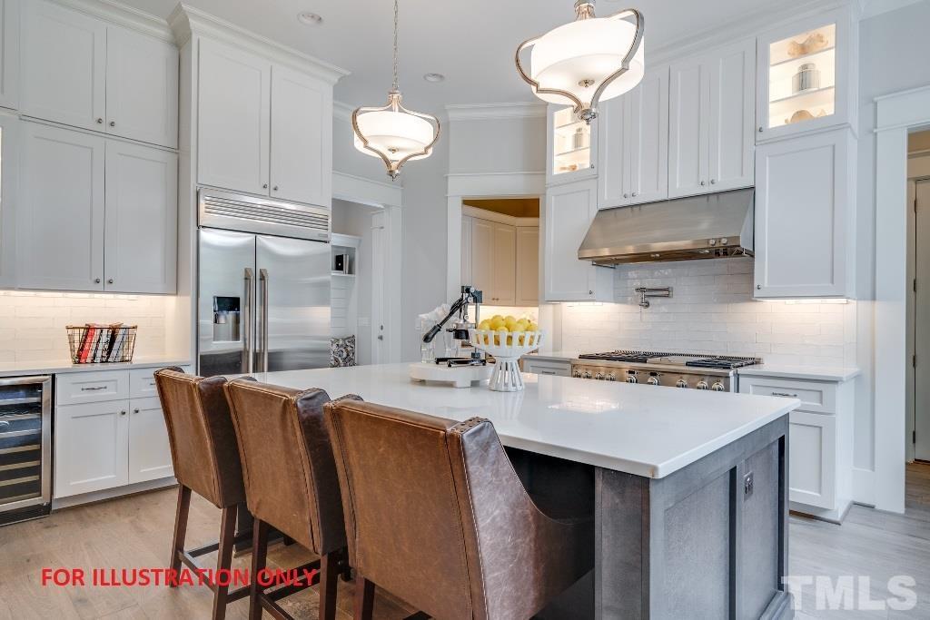 1317 Westfield Avenue Raleigh, NC 27607 - Photo 3 of 29 a kitchen with stainless steel appliances a table chairs and a refrigerator
