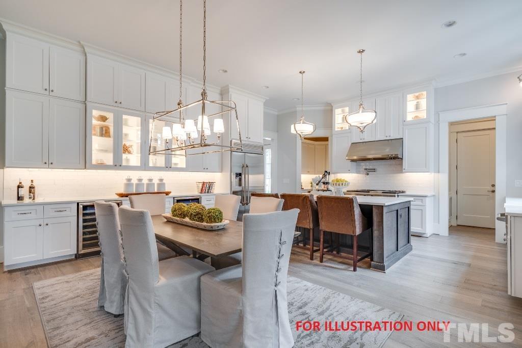 1317 Westfield Avenue Raleigh, NC 27607 - Photo 4 of 29 a dining room filled a chandelier and kitchen view