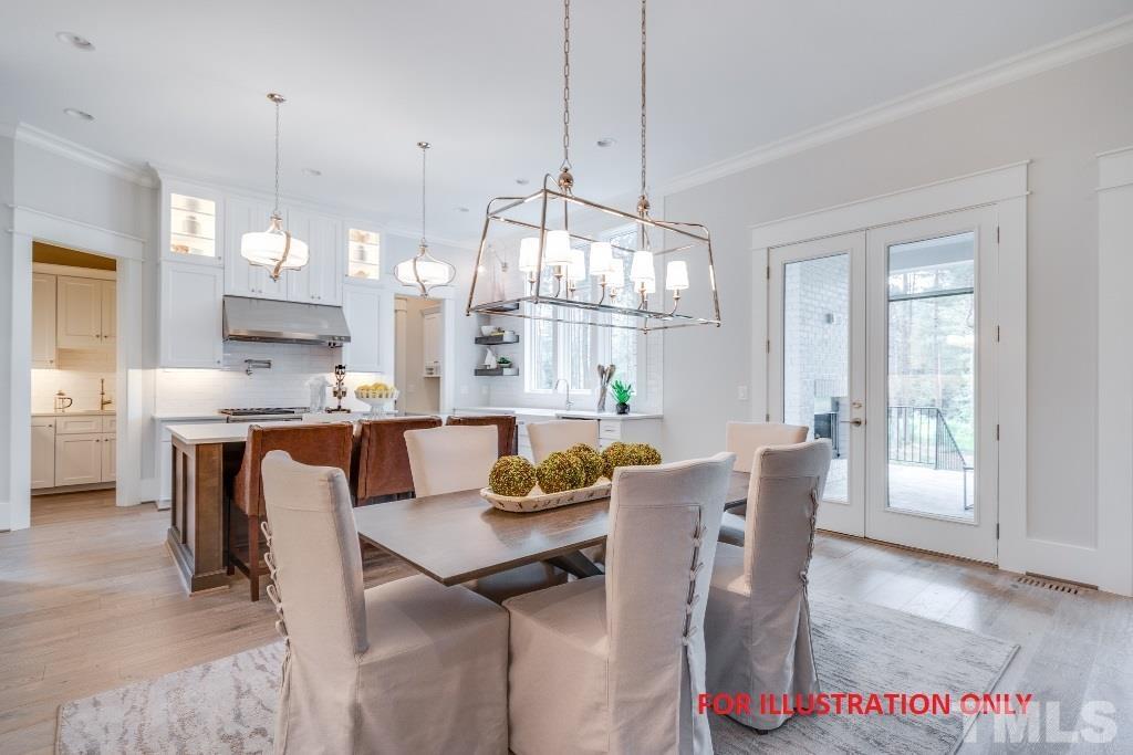 1317 Westfield Avenue Raleigh, NC 27607 - Photo 5 of 29 a view of a dining room and livingroom with furniture wooden floor a chandelier
