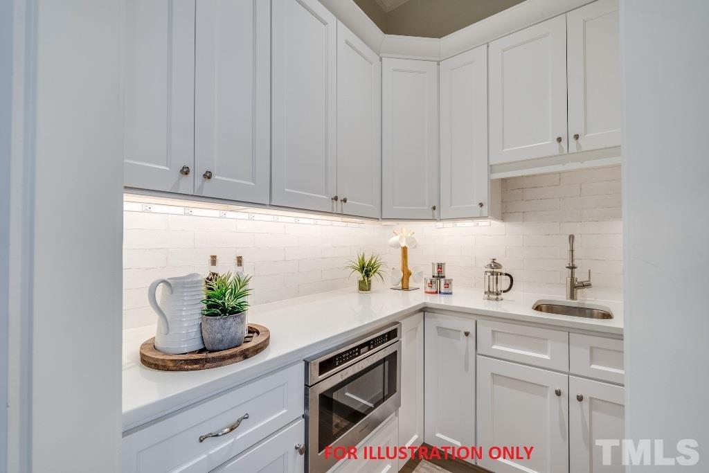 1317 Westfield Avenue Raleigh, NC 27607 - Photo 7 of 29 a kitchen with stainless steel appliances white cabinets and a sink