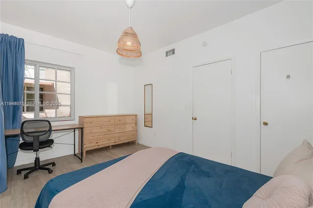 a bedroom with a bed and a chair