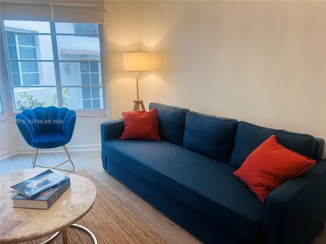 a living room with furniture and a lamp