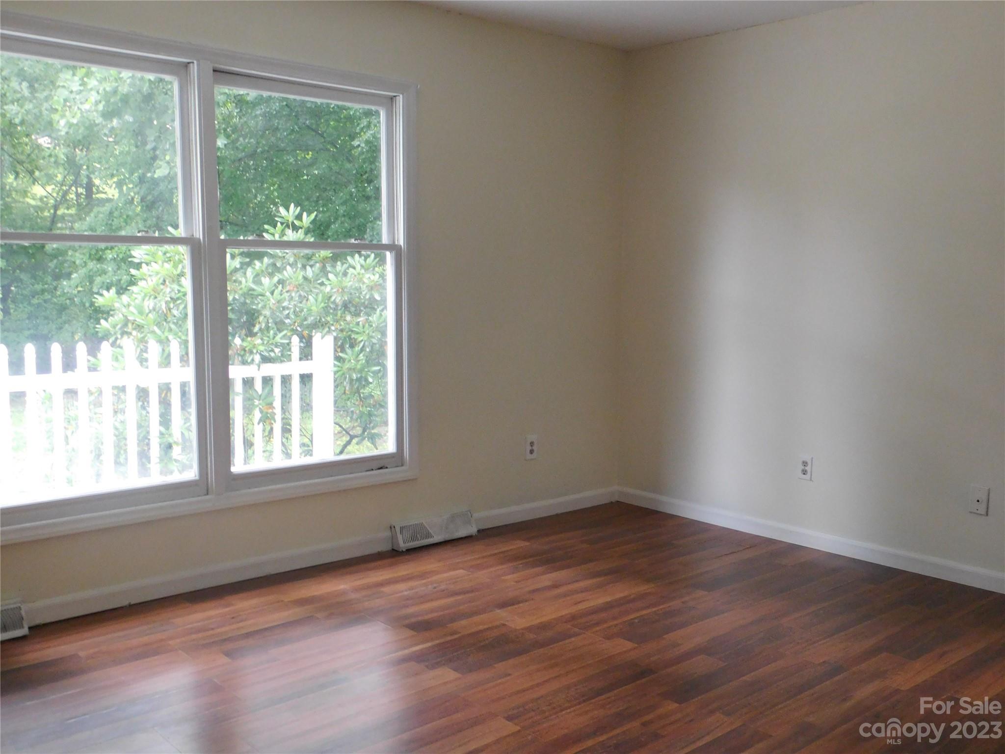 923 Fanning Bridge Road Fletcher, NC 28732 - Photo 8 of 30 a view of an empty room with wooden floor and a window