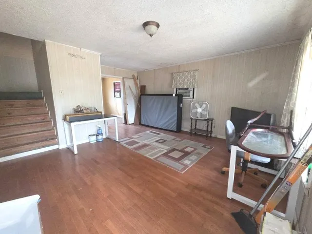 a livingroom with furniture and a flat screen tv