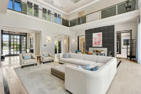 a room with stainless steel appliances kitchen island granite countertop a sink and cabinets