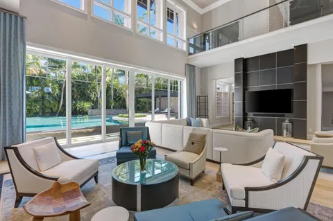 a balcony with furniture and a large window