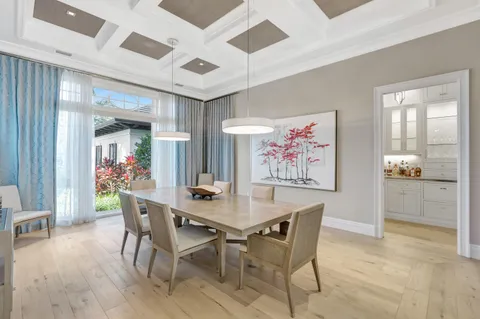 a living room with furniture flat screen tv and a large window