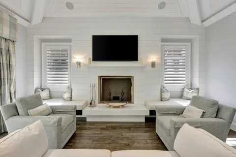 a front view of a house with a yard and potted plants