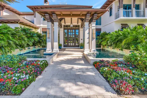 a living room with patio furniture and a flat screen tv