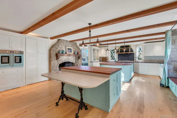 a kitchen with kitchen island a stove and a table