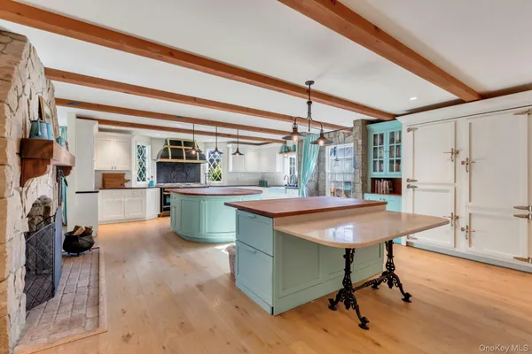 a kitchen with kitchen island a stove a sink and a refrigerator