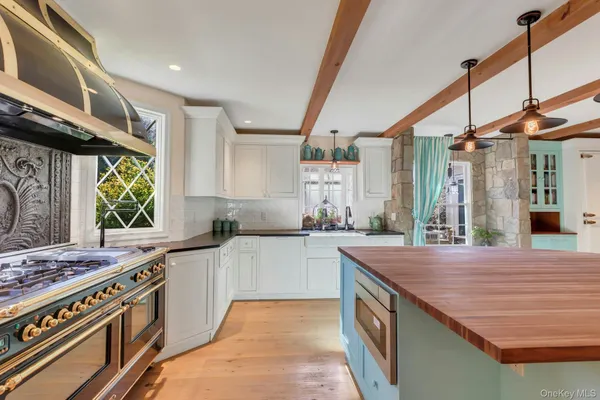 a kitchen with stainless steel appliances granite countertop a stove and a sink