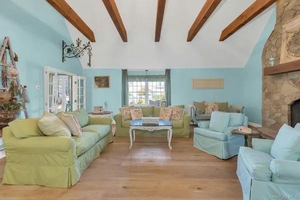 a view of a livingroom with furniture and a window
