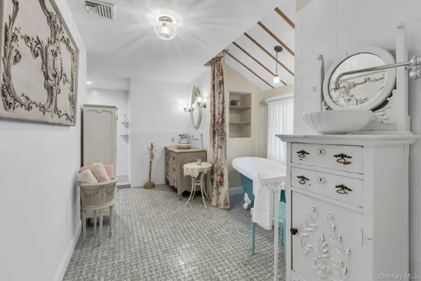 a bathroom with a sink tub and a mirror